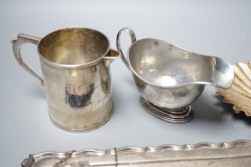 A George V silver sauceboat, an Edwardian silver pen tray and three other items including shell butter dish, 18oz.